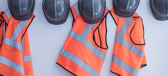 High-visibility vests and safety boots laid out, ready for site work