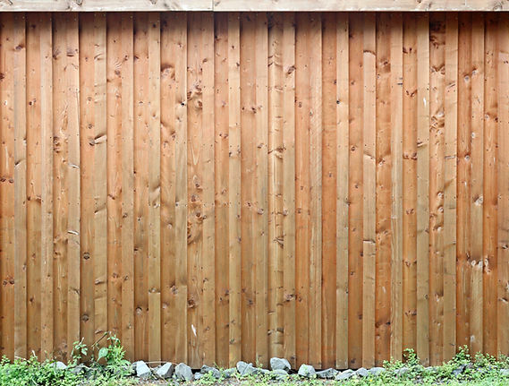 A clean timber garden fence panel with a narrow stone border
